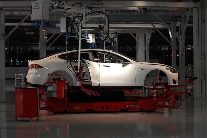 A Tesla Model S body on an assembly carrier inside the Fremont factory